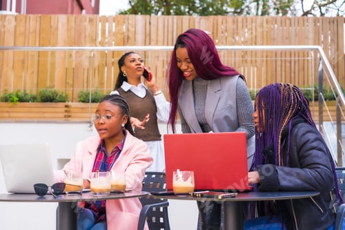 Preview: Young businesswomen of black ethnicity. In a business meeting in a cafeteria