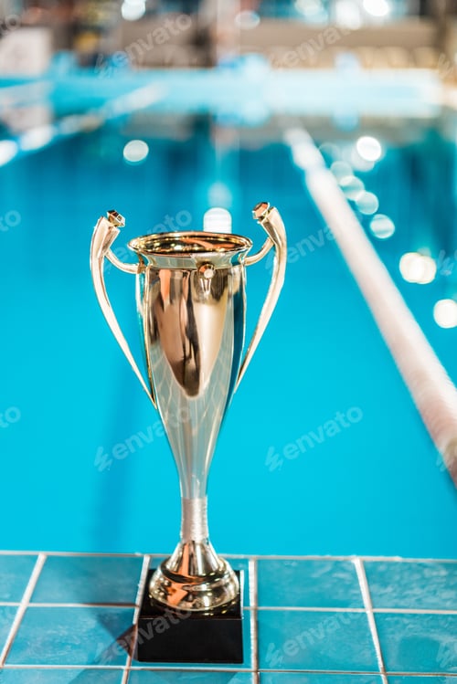 Preview: golden trophy cup at competition swimming pool