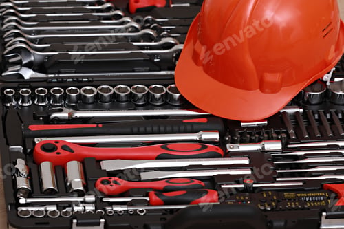 Preview: Toolbox, tools kit detail and orange protective helmet close up. instruments. set of tools.