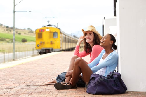 Preview: Female friends waiting for train at railroad station