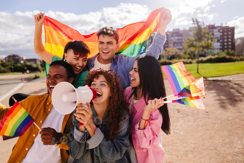 Preview: Young activists shouting with megaphone at lgbtq pride parade