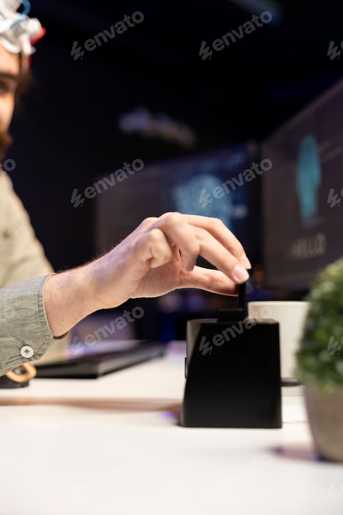 Preview: Close up of developer putting disk in PC to start consciousness upload