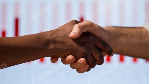 Preview: Handshake in the office: two men shake hands on the background of multimedia