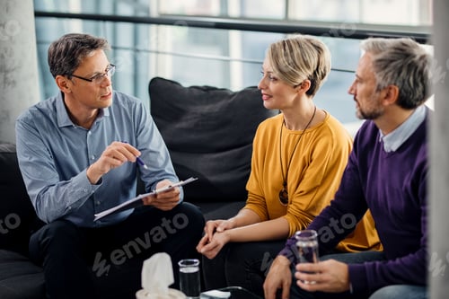 Preview: Male therapist talking to a couple during a meeting in the office.