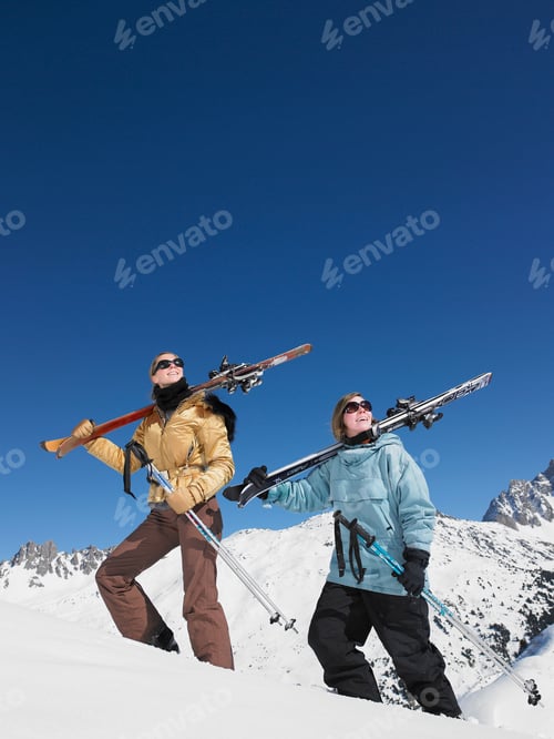 Preview: Skiers climbing mountain admiring view