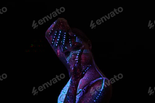 Preview: Art woman cosmos in ultraviolet light. Entire body is covered with colored droplets.