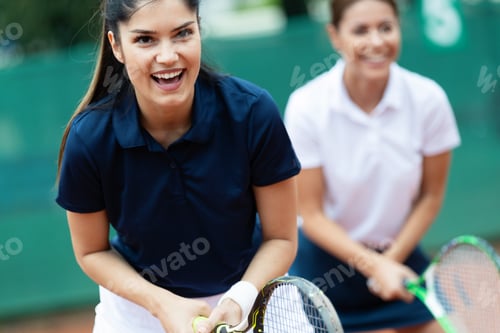 Preview: Group of healthy happy friends at the club playing tennis