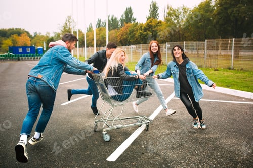 Preview: Group of four young diverse friends in jeanse outfit look carefree, young and happy on city's