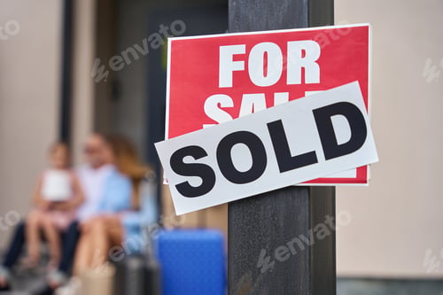 Preview: Close up sign for sale. Family sitting on steps