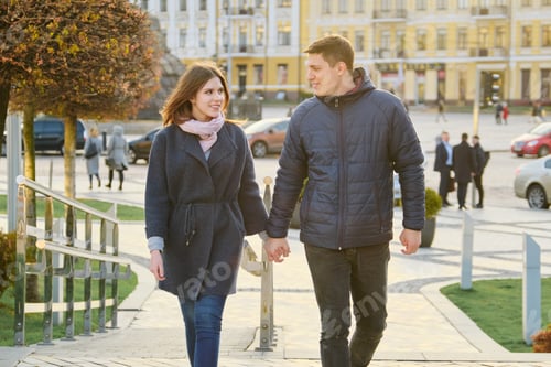 Preview: Young couple happy man and woman holding hands