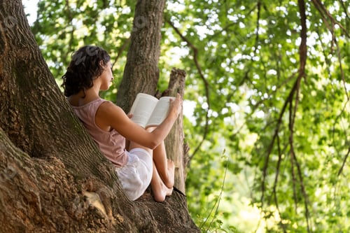 Preview: Portrait of a woman reading in a forest