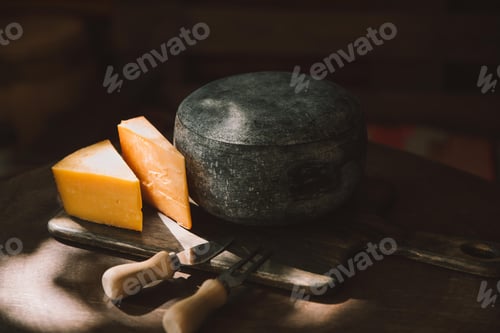 Preview: two sorts of cheese and cutlery on rustic wooden table