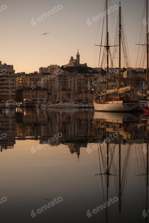 Preview: On water with buildings and birds in the background during sunset