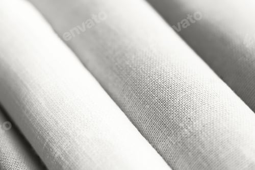Preview: Diagonal textural background of cloud white dancer natural linen fabric, rolled up