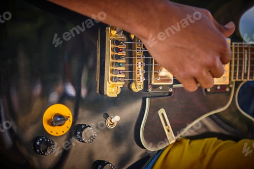 Preview: Man playing electric guitar detail. Musician. Musical instrument