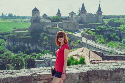 Preview: The Girl Is Photographed Against The Background Of The Castle. The Old Castle Of Kamyanets-Podilsky