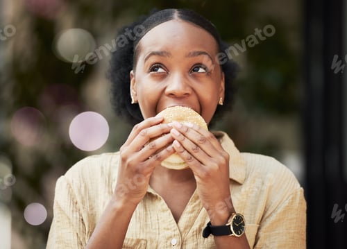 Preview: Thinking, fast food and black woman biting a burger in an outdoor restaurant as a lunch meal cravin