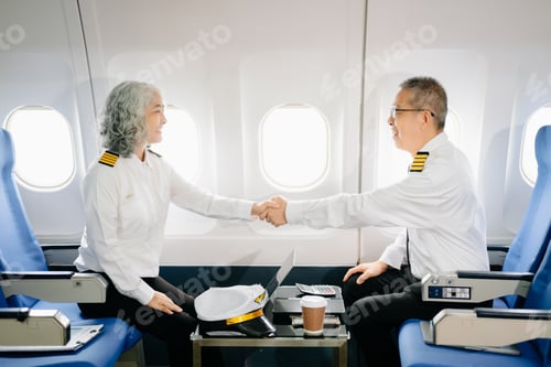 Preview: Mature commercial male pilot Beautiful middle aged woman airplane captain instructor has a meeting