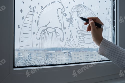 Preview: Creative enthusiastic unrecognizable woman in sweater paint window with white marker. Festive gnomes