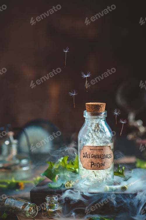 Preview: Glass potion bottle with dandelion seeds and handcrafted label in a magical still life with smoke