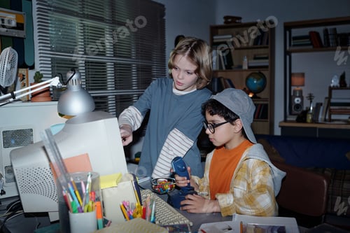 Preview: Children Exploring Technology in Dimly Lit Room