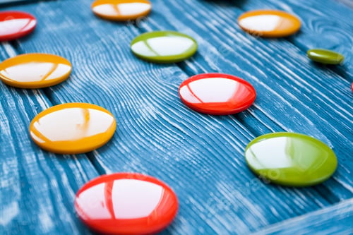 Preview: A set of colorful glass buttons for clothes on a dark wooden background