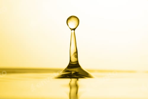 Preview: Splash of golden oily liquid on white background, closeup