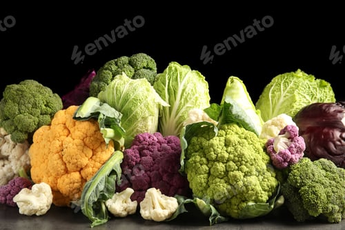 Preview: Different fresh cabbages on table against black background. Healthy food