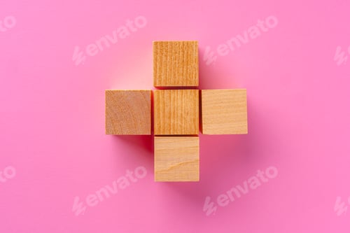 Preview: Top view of toy wooden blocks on pink