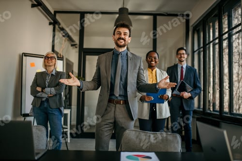Preview: Business team celebrating success in modern office after corporate meeting