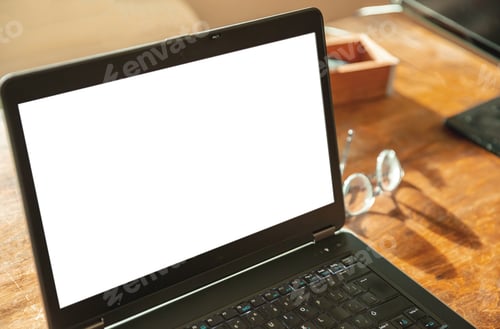 Preview: Computer screen mockup. Laptop with white blank screen on a wood desk, office background, copy space