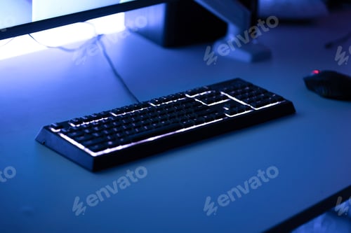 Preview: mechanical gaming computer keyboard with rgb led backlight on the table at night