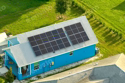 Preview: Aerial view building roof with rows of blue solar photovoltaic panels