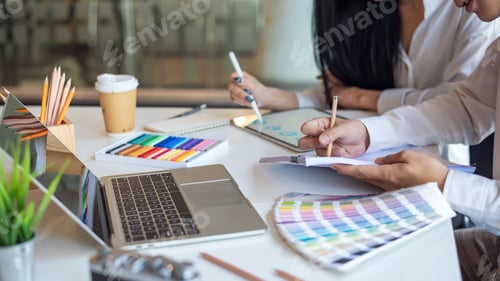 Preview: Close-up of the design team working together to their ideas using tablet palette at the office.