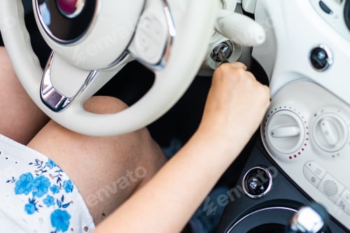 Preview: Hand putting car key to the keyhole starting car