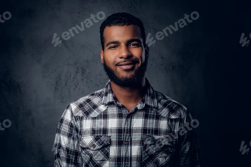 Preview: Portrait of Black, bearded male dressed in a fleece shirt.