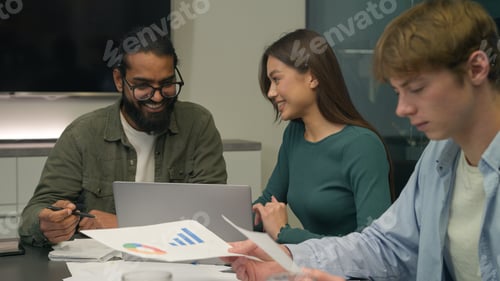 Preview: Happy team coworkers colleagues managers man woman talk laugh discuss project on laptop business