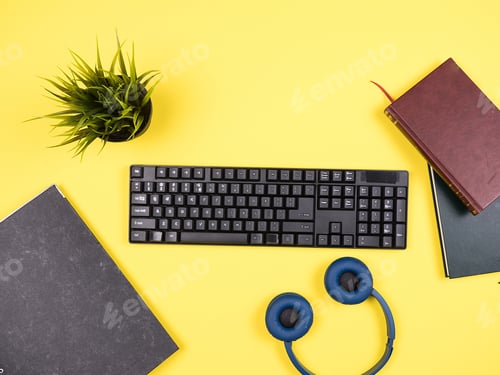 Preview: Top view of keyboard, folder and headphones