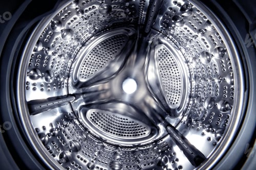 Preview: Inside of a shine steel drum of the washing or dryer machine. Laundry day. Daily household
