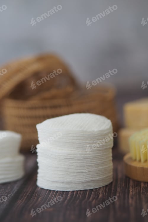 Preview: Cotton pads and body brushes arranged on wooden surface