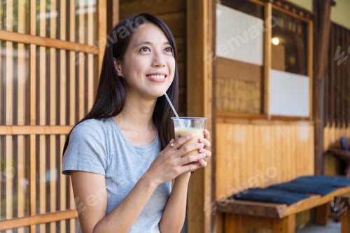 Preview: Woman drinking of coffee in cafe