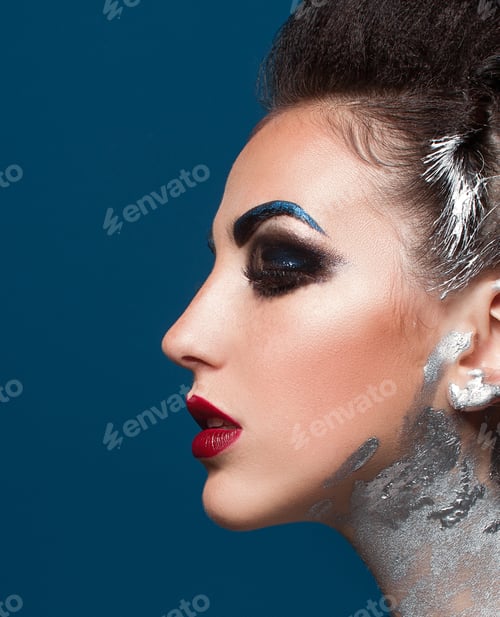 Preview: Girl With Creative Make-Up On A Blue Background