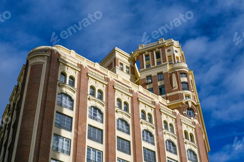 Preview: Low-angle shot of a beautiful architectural building under a blue sky with clouds in Madrid, Spain.