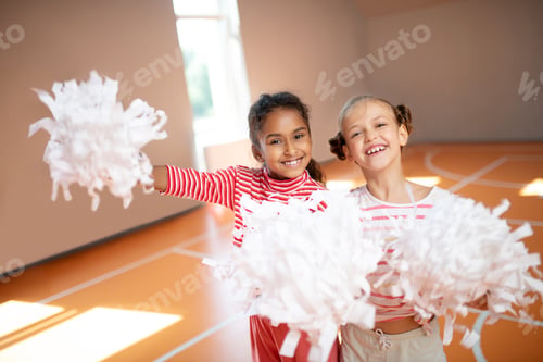 Preview: Best friends smiling while practicing cheerleading together