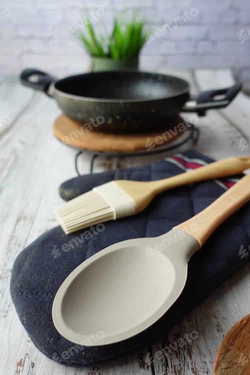 Preview: wooden cutlery fork and spoon and cooking pan on table