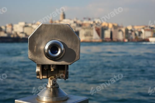 Preview: Coin-operated binoculars looking out over city ,