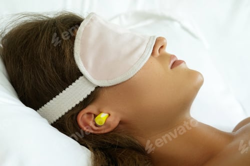 Preview: Woman is wearing eye mask and using earplugs