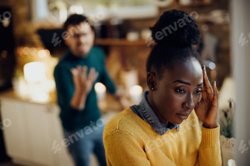 Preview: Distraught African American woman having relationship difficulties with her boyfriend at home.