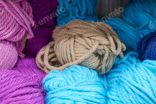 Preview: Multicolored blue green yarn balls in knitting shop, macro