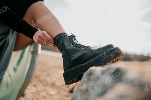 Preview: Brutal shoes. Woman in silk skirt corrects socks. Military trendy boots.